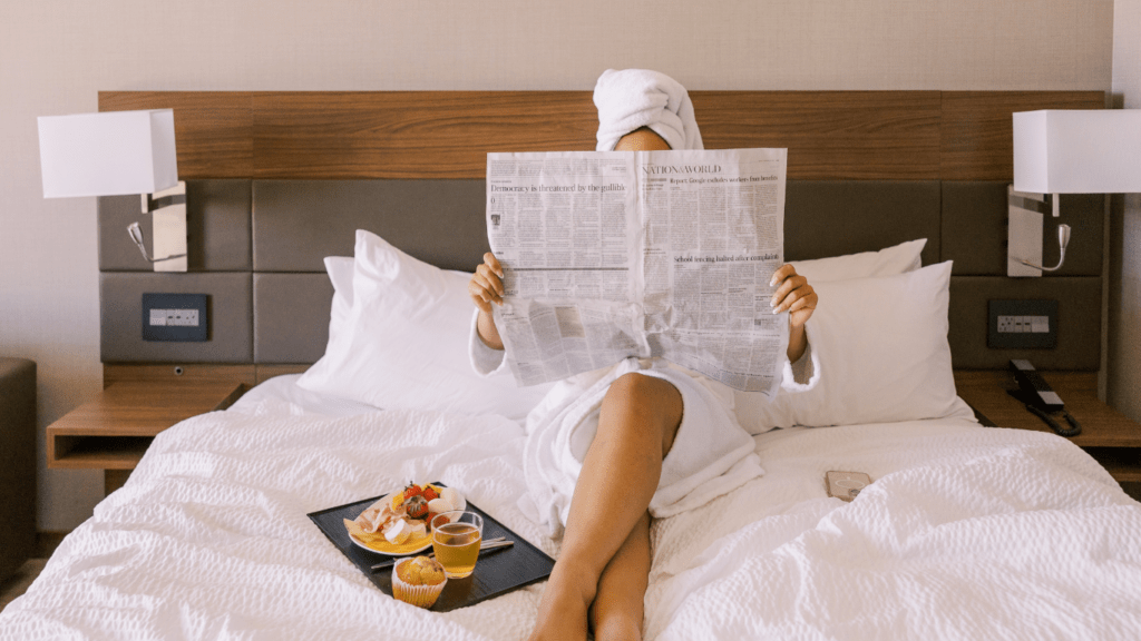 a woman sitting on a hotel bed