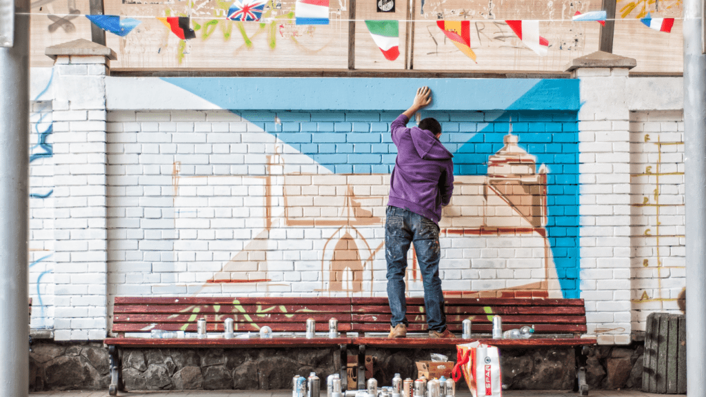 an artist painting a wall