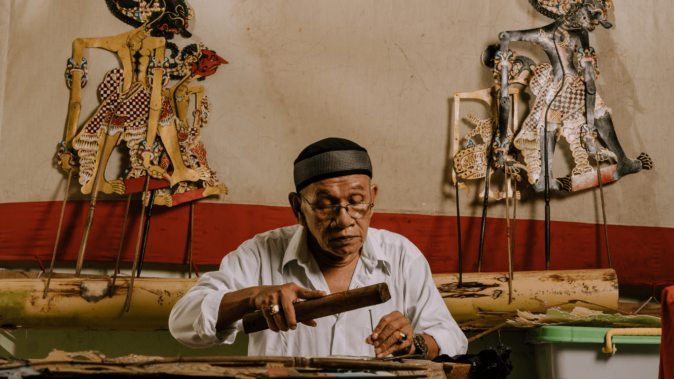 a indigenous man doing tattoo art