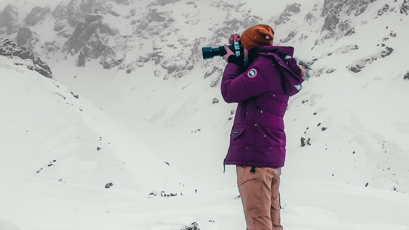 a woman taking photograph of a scenery