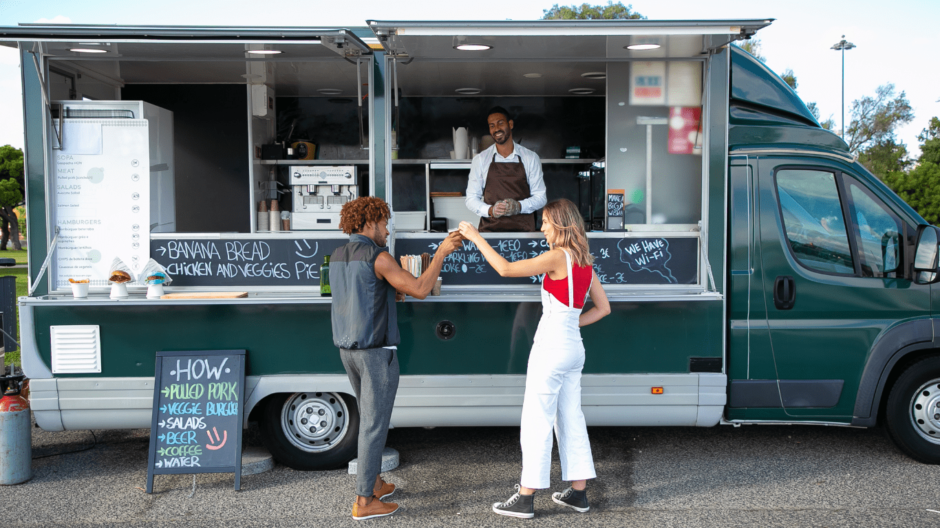 a man selling in a food truck