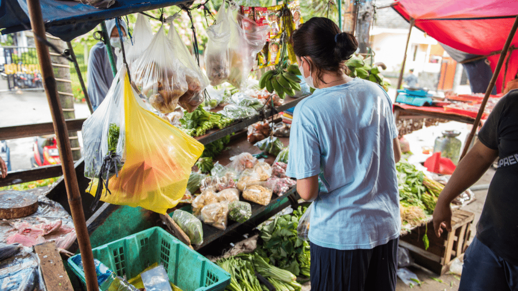 a woman buying in a local food market