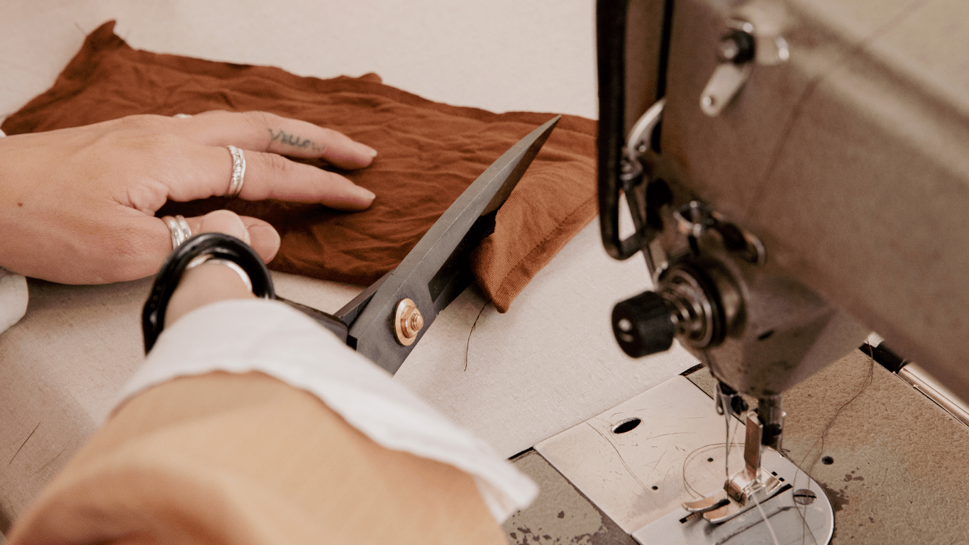 a designer cutting a piece of fabric