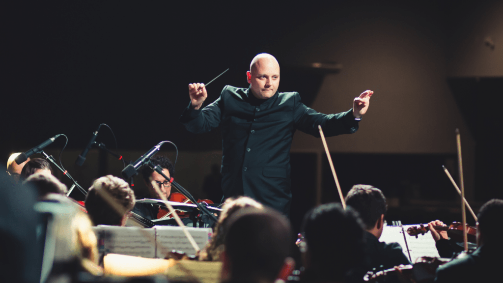 a man directing orchestra