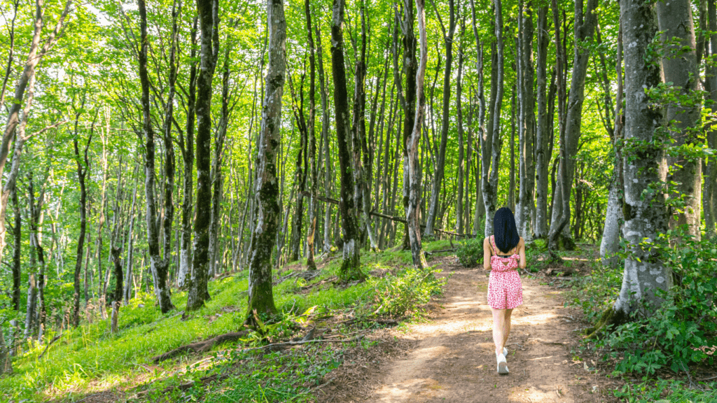 a woman walking in a trail park